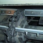 nylon scrapers mounted on welded links, shown with sprocket