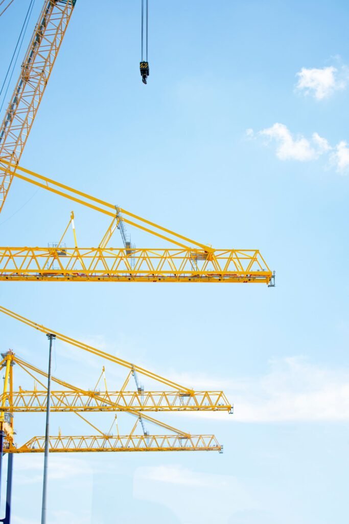 Tower cranes on a construction site against a clear sky