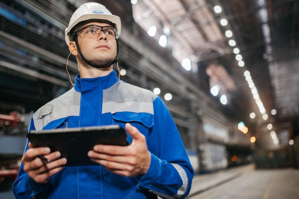 Engineer reviewing specifications on a tablet in a factory