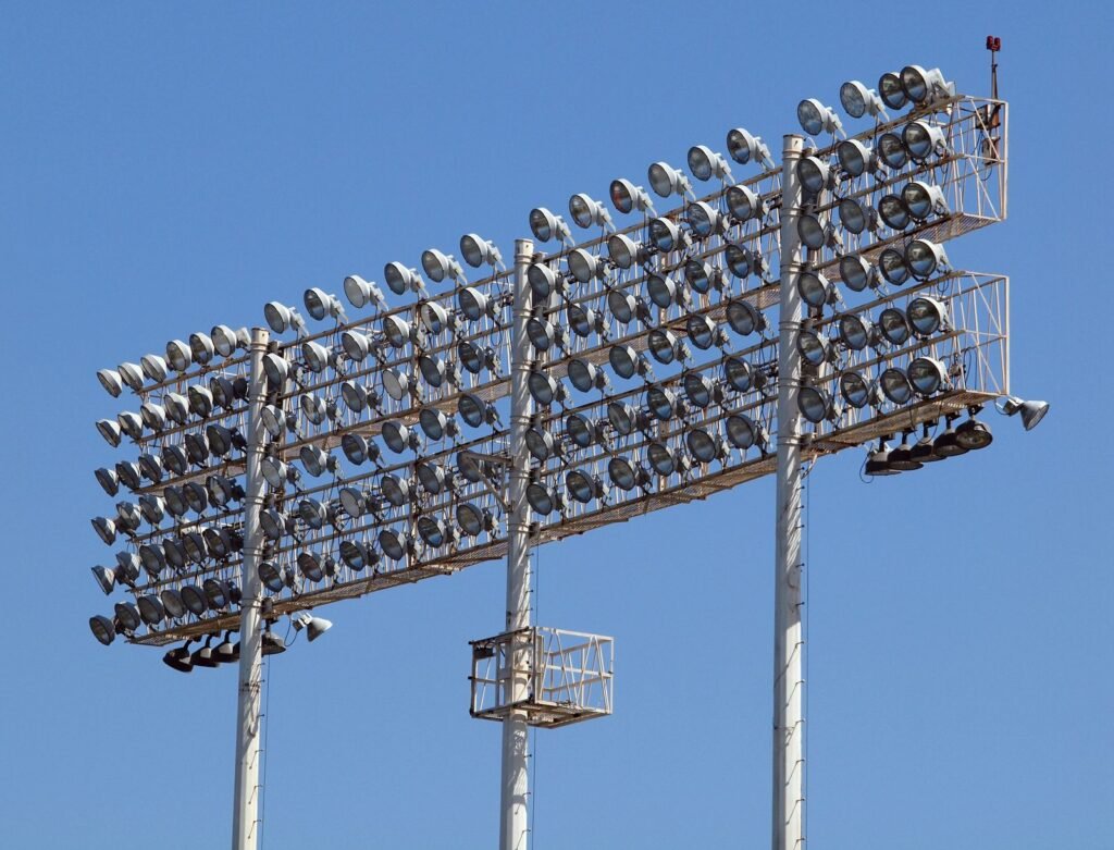 Floodlight towers against a clear blue sky